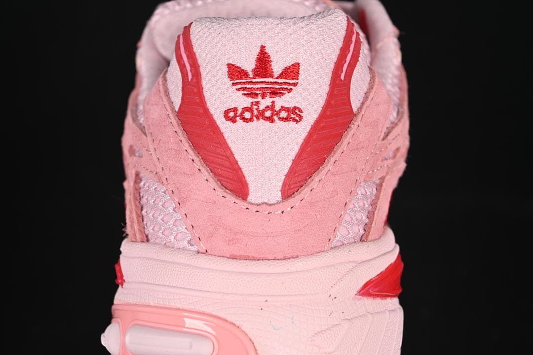 Rear view of the pink sneaker with red adidas branding.