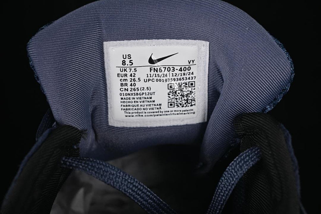 Nike shoe size label showing US 8.5, UK 7.5, EUR 42, and style code FN6703-400