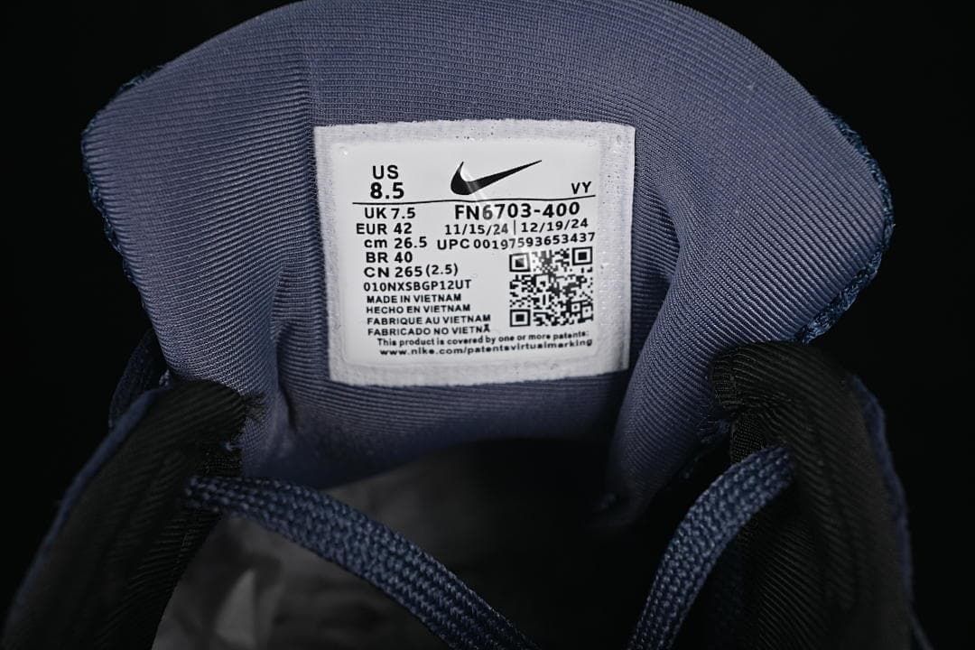 Nike shoe size label showing US 8.5, UK 7.5, EUR 42, and style code FN6703-400
