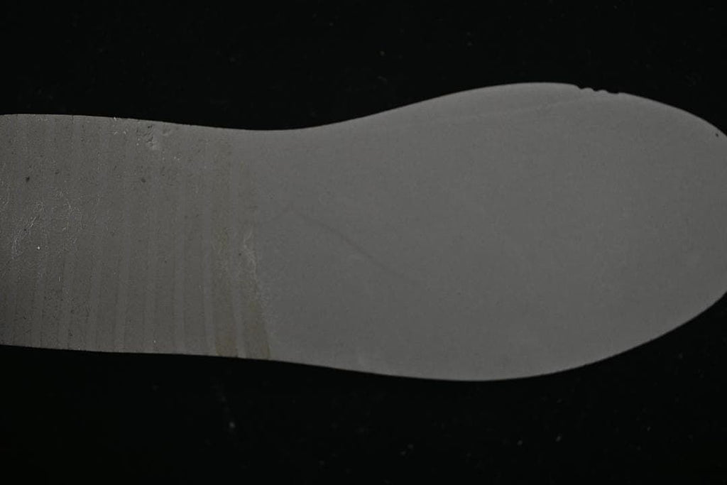 Underside view of a light-colored sneaker insole