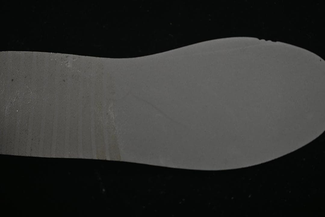 Underside view of a light-colored sneaker insole