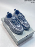 Pair of gray layered-panel lace-up sneakers displayed on a box
