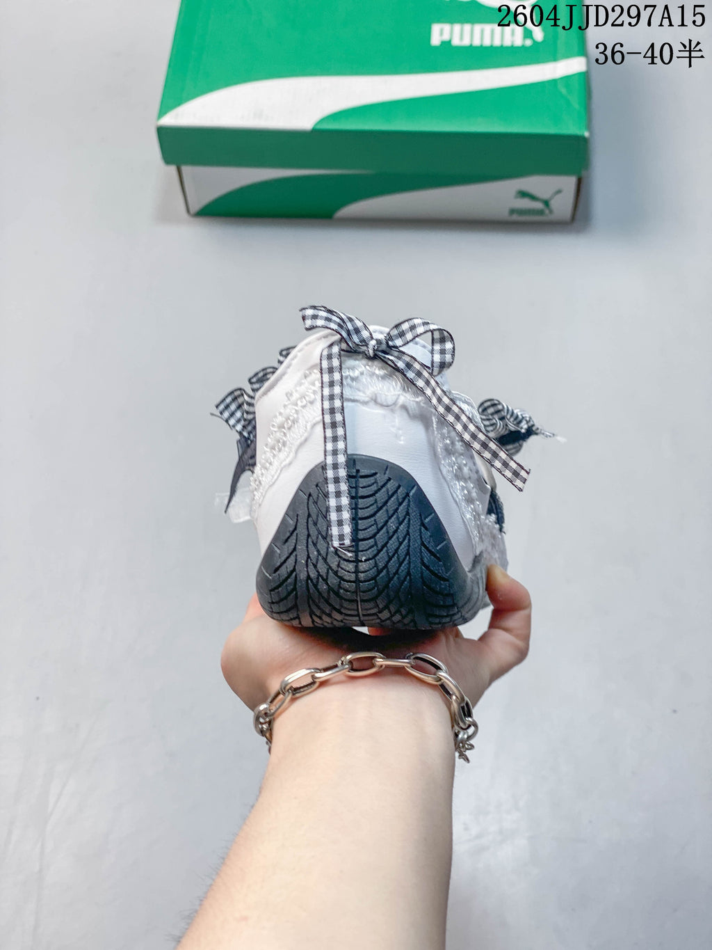 Rear view showing the dark patterned outsole and gingham bow detail.