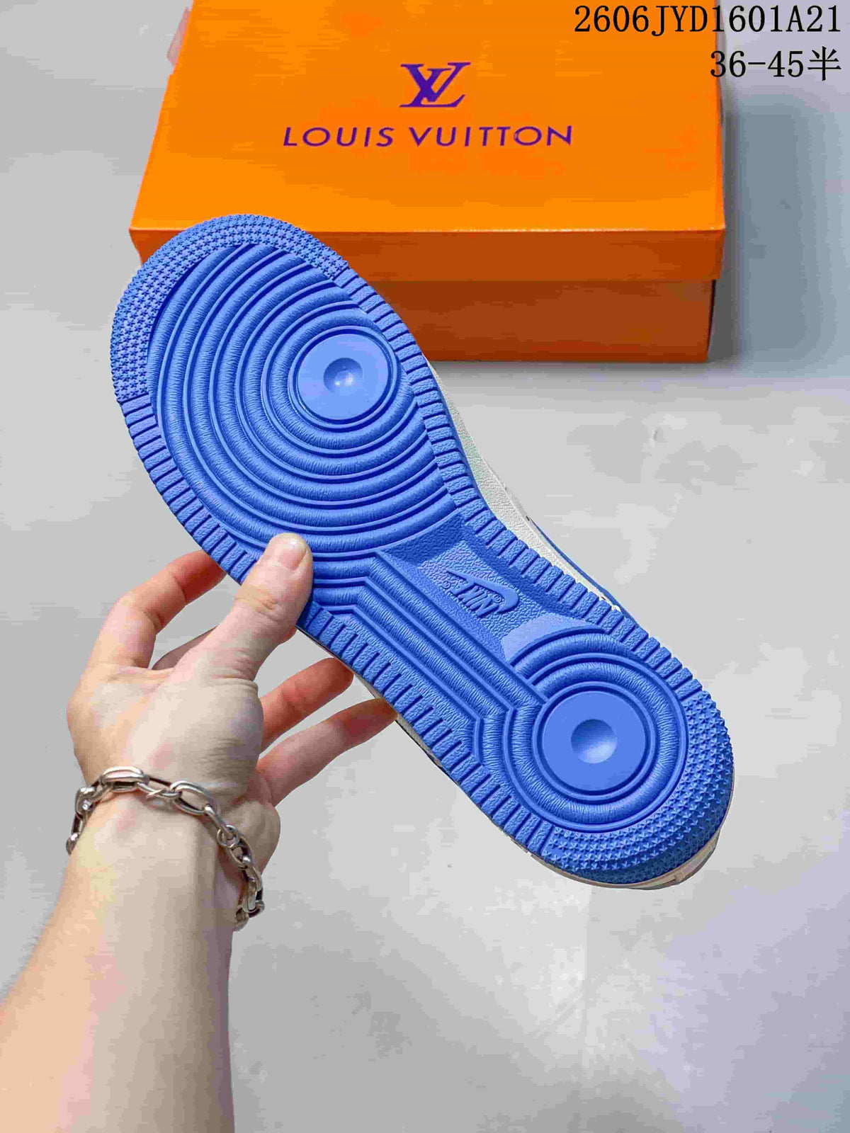 Blue outsole of a white sneaker with an orange box in the background