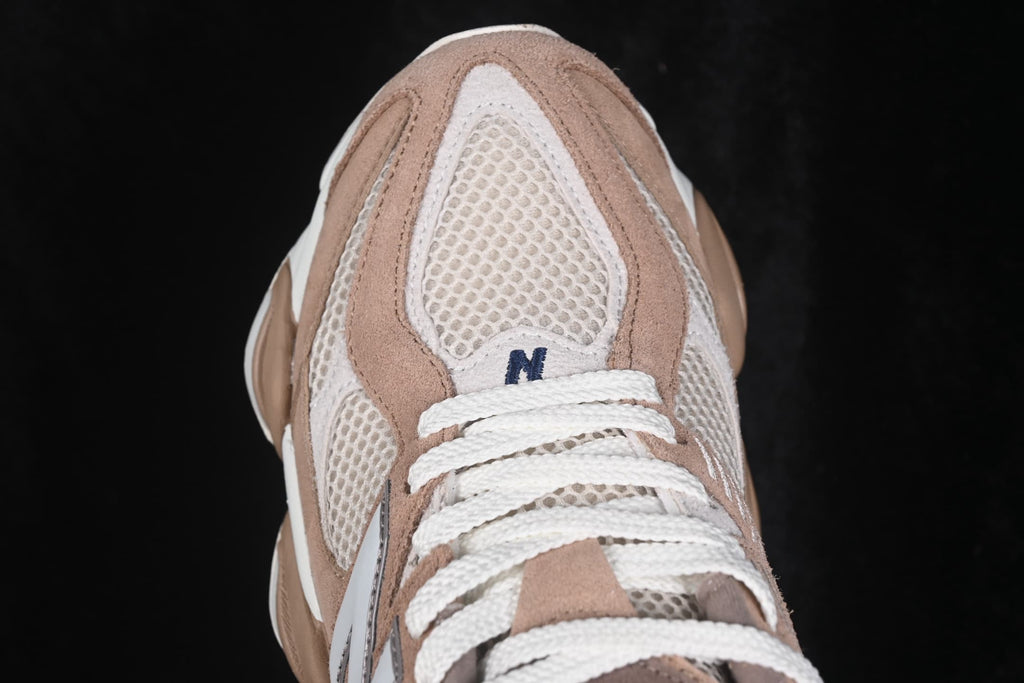 Close-up of the mesh toe box, white laces, and layered beige overlays.