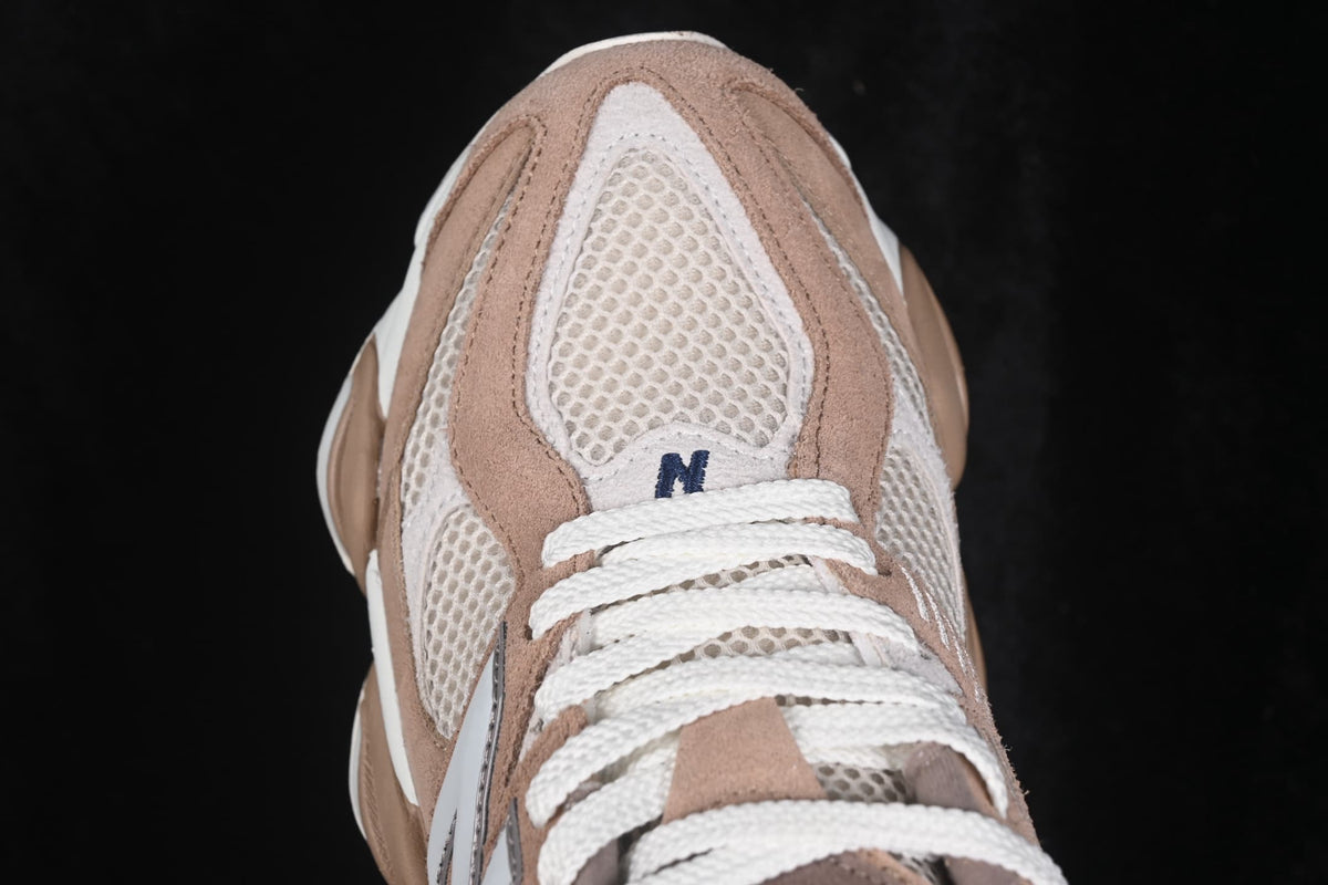 Close-up of the mesh toe box, white laces, and layered beige overlays.