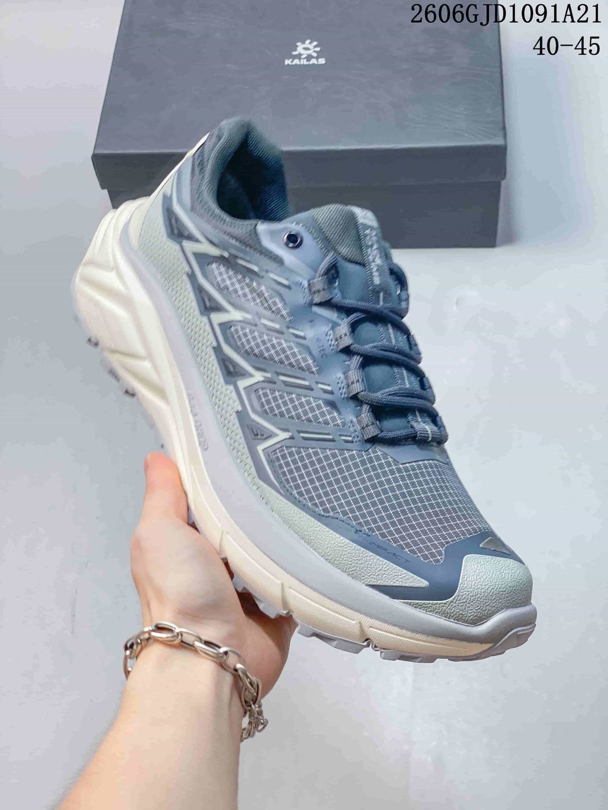 Close side view of a gray-blue KAILAS trail-running shoe with a lugged outsole.