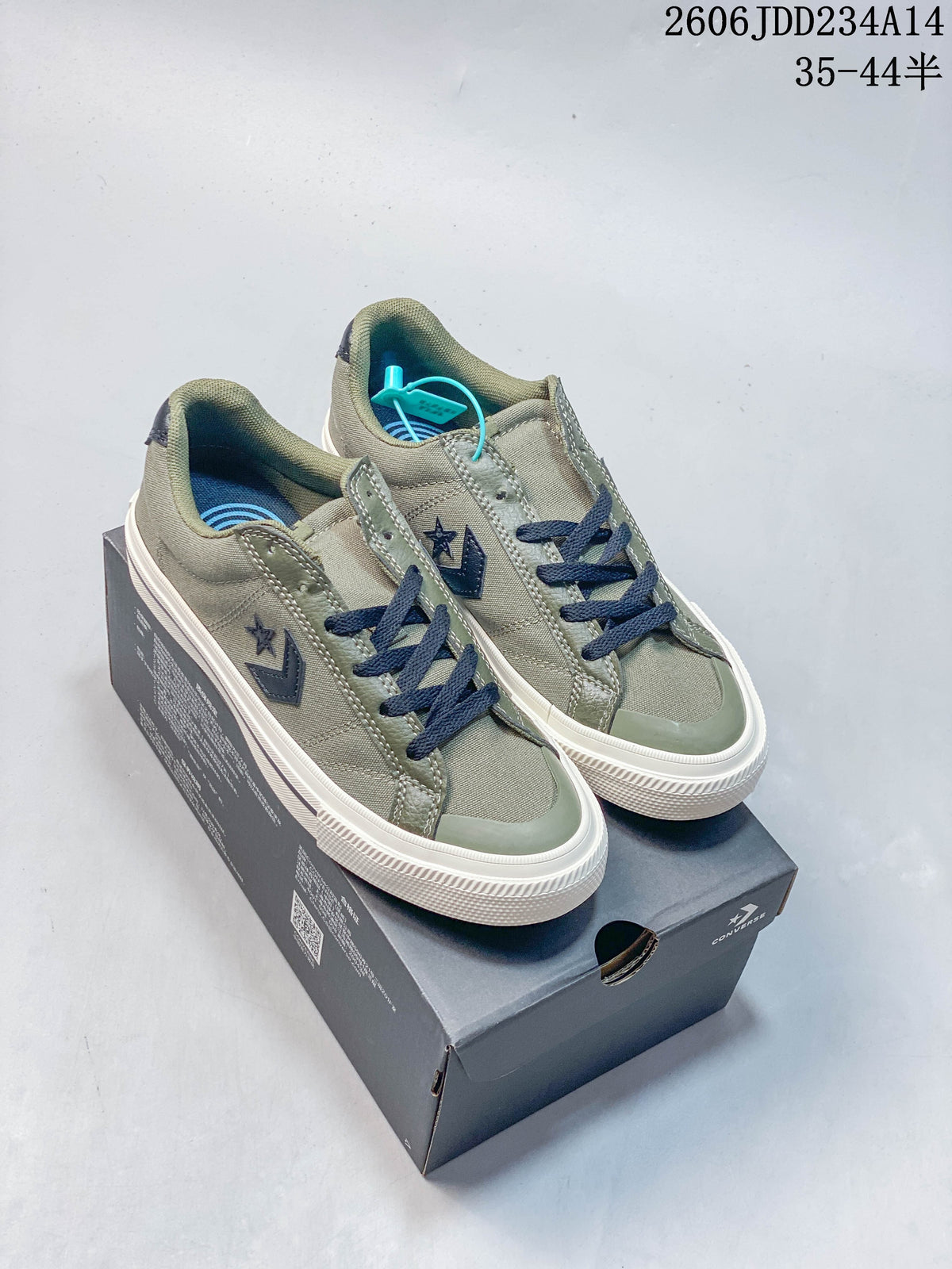 Olive and navy Converse low-top lace-up sneakers displayed on a box