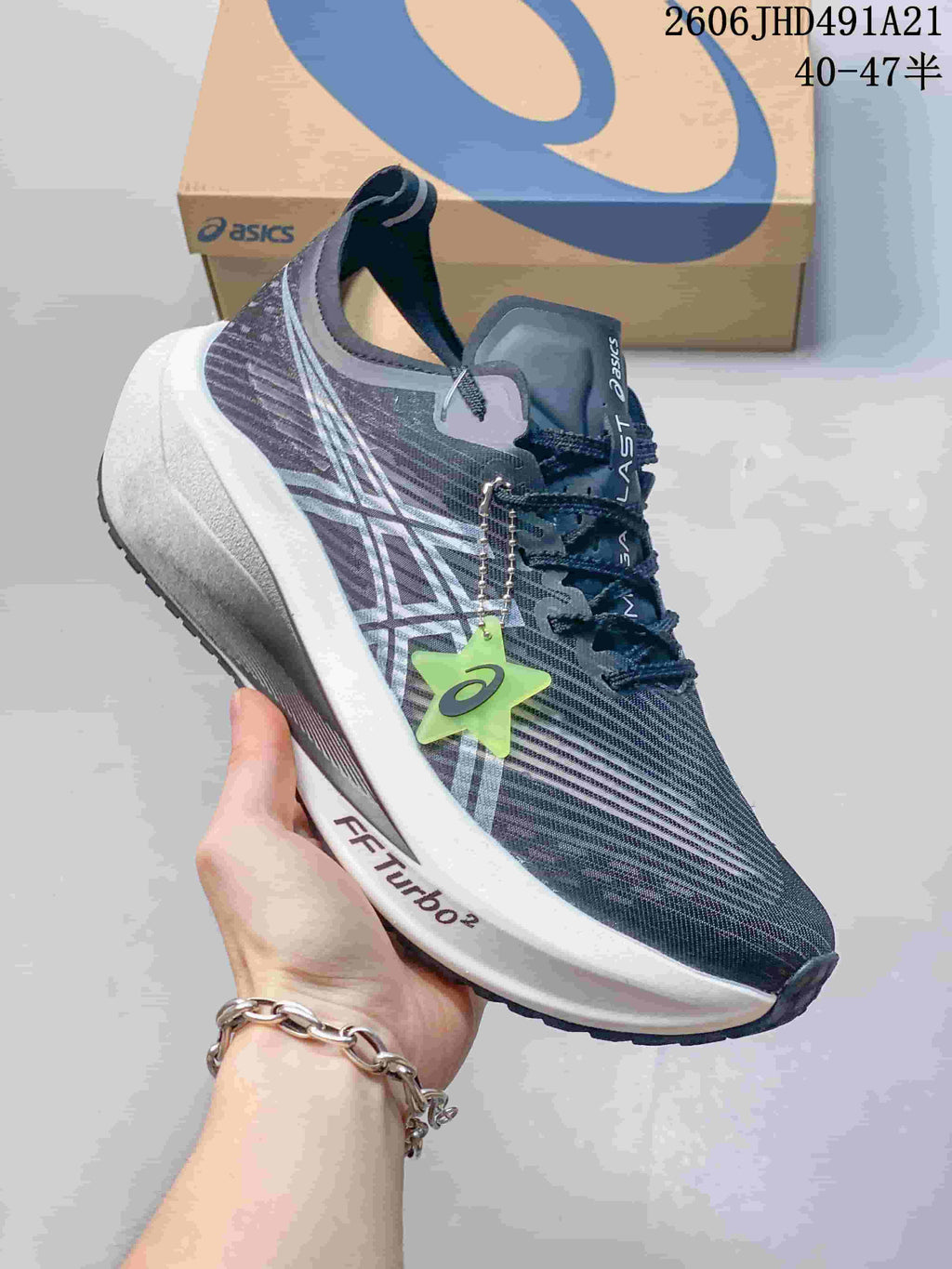 Close side view of the shoe showing the ASICS stripes and FF TURBO 2 midsole marking