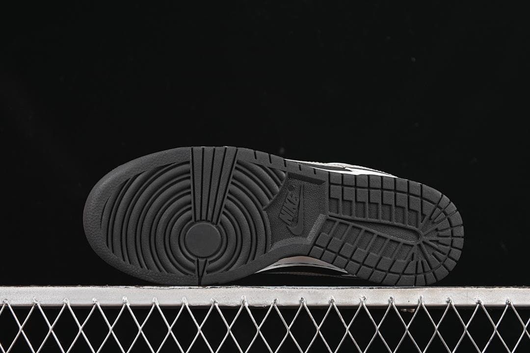 Underside view of the black rubber outsole and circular tread