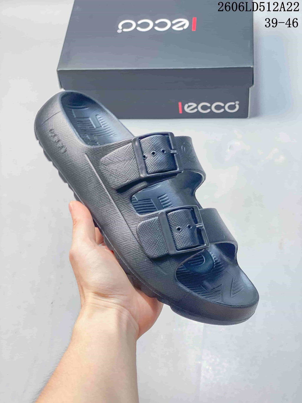 Angled view of a dark gray two-strap sandal with adjustable buckles; image displays style code 2606LD512A22 and sizes 39–46.