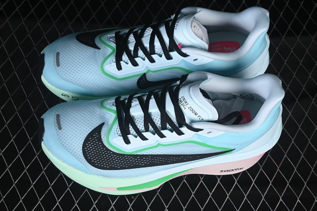 Pair of pale blue and white Nike Zoom Fly 6 running shoes with colorful accents.