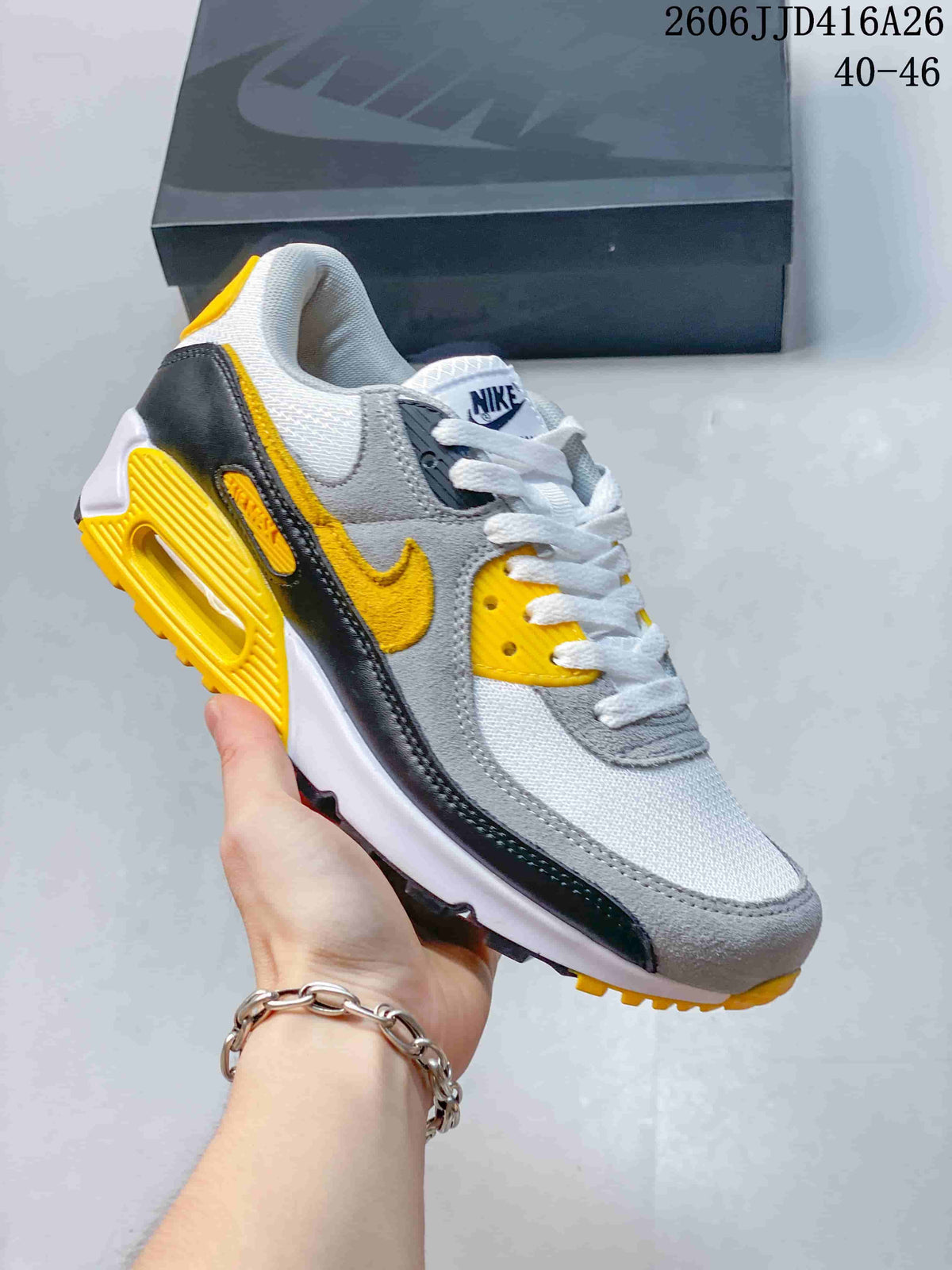 Gray, white, black, and yellow Nike Air Max 90 sneaker.