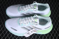 Pair of white Velostar KI6015 sneakers with silver stripes and mint and lime accents