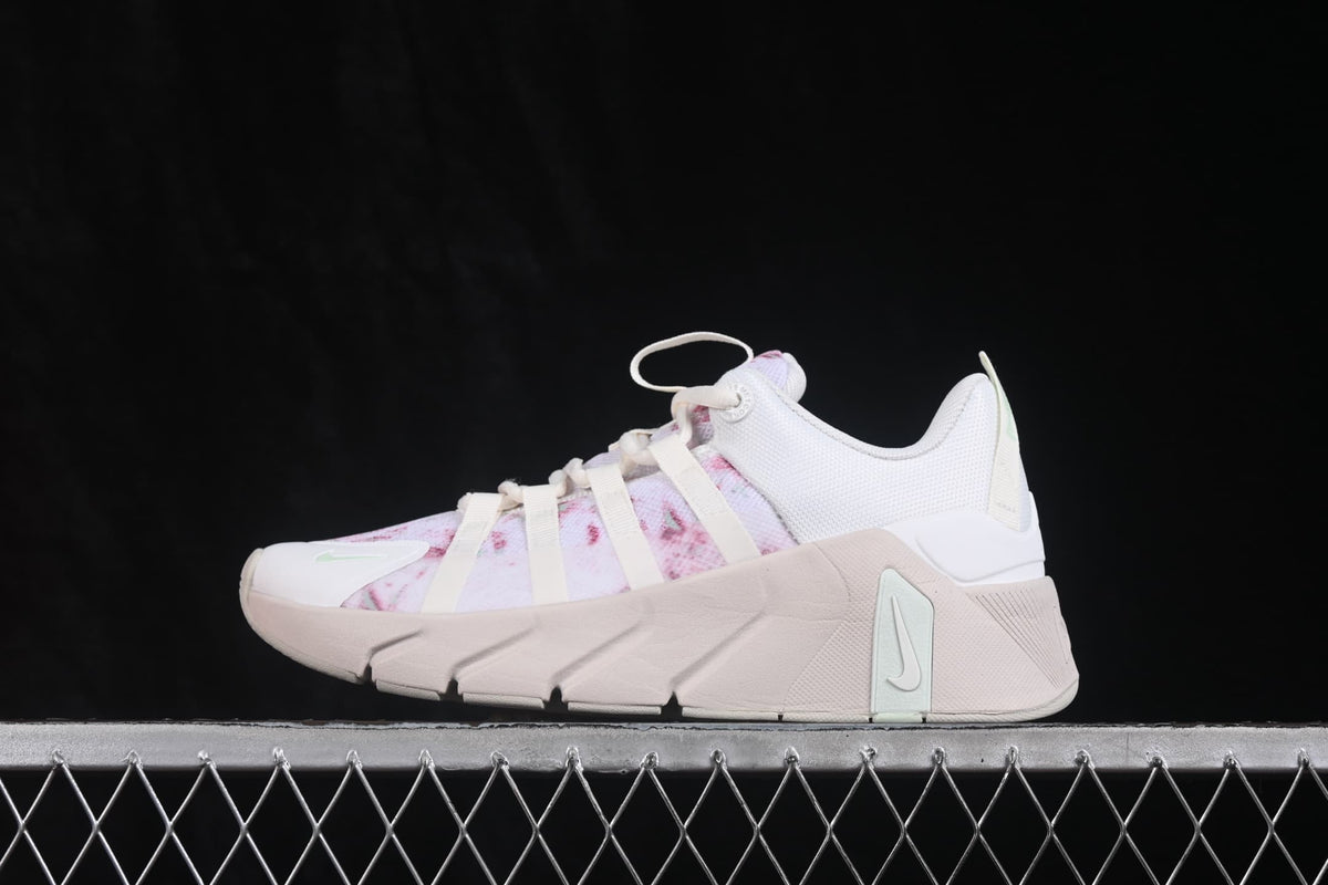 Opposite side profile showing the white heel section, pink patterned upper, and mint accent on the sole.