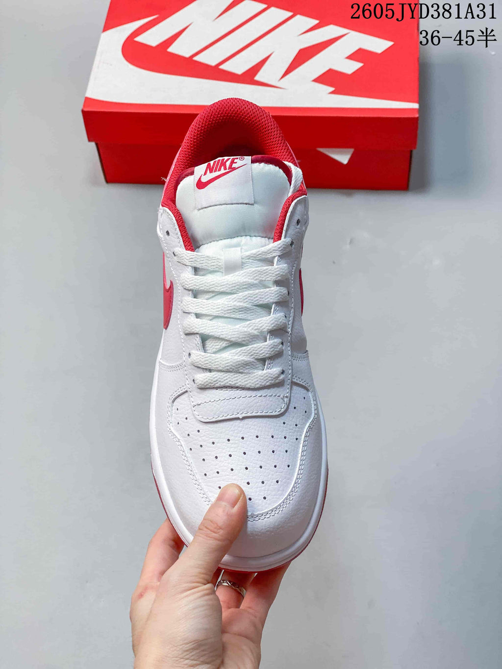 Front view showing the perforated toe, white laces and red collar lining