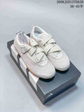Pair of light-colored adidas Urban Reverie low-top shoes with crossing straps and gum-colored soles