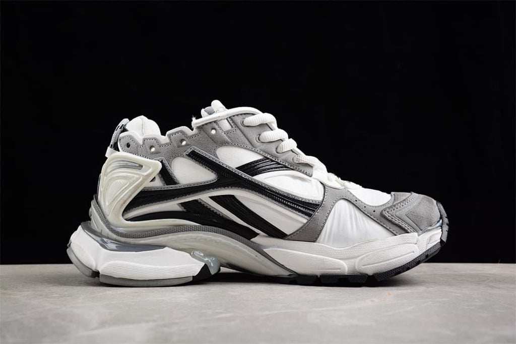 Side profile highlighting the layered panels and sculpted sole