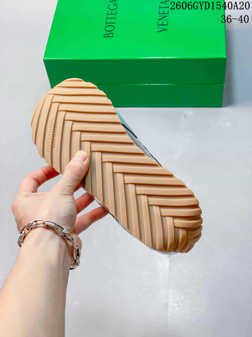 Close-up of the ridged gum-colored outsole and green Bottega Veneta box