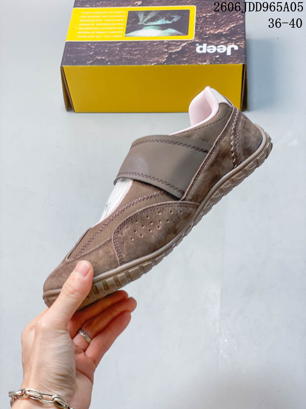 Side profile of the brown Mary Jane-style shoe with a broad strap and low-profile sole