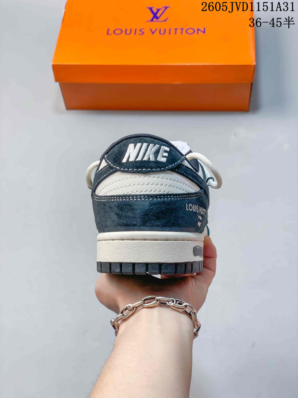 Rear view showing the heel, navy overlay, and white midsole.