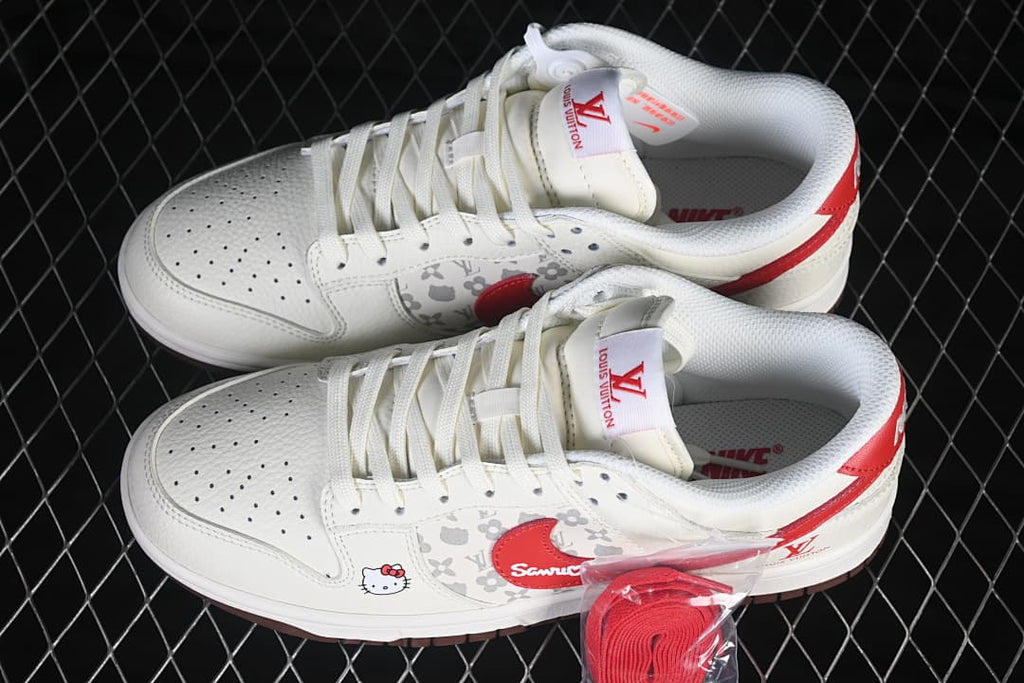 Pair of cream and red low-top sneakers with patterned side panels, character graphics, and a spare red lace.