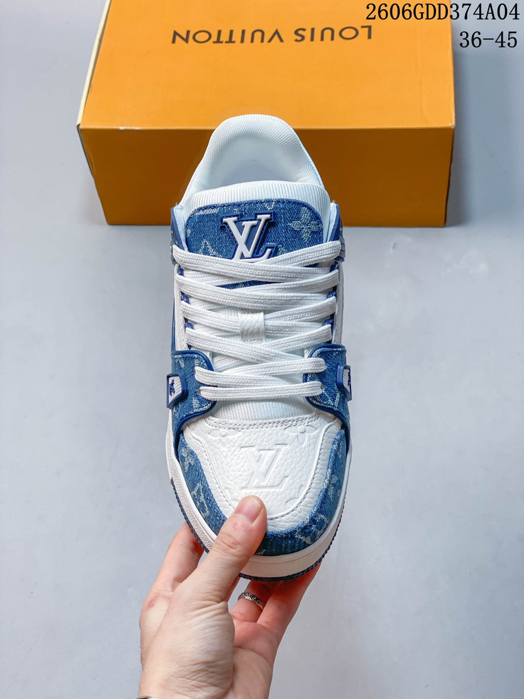 Front view of the sneaker with white laces and blue patterned tongue