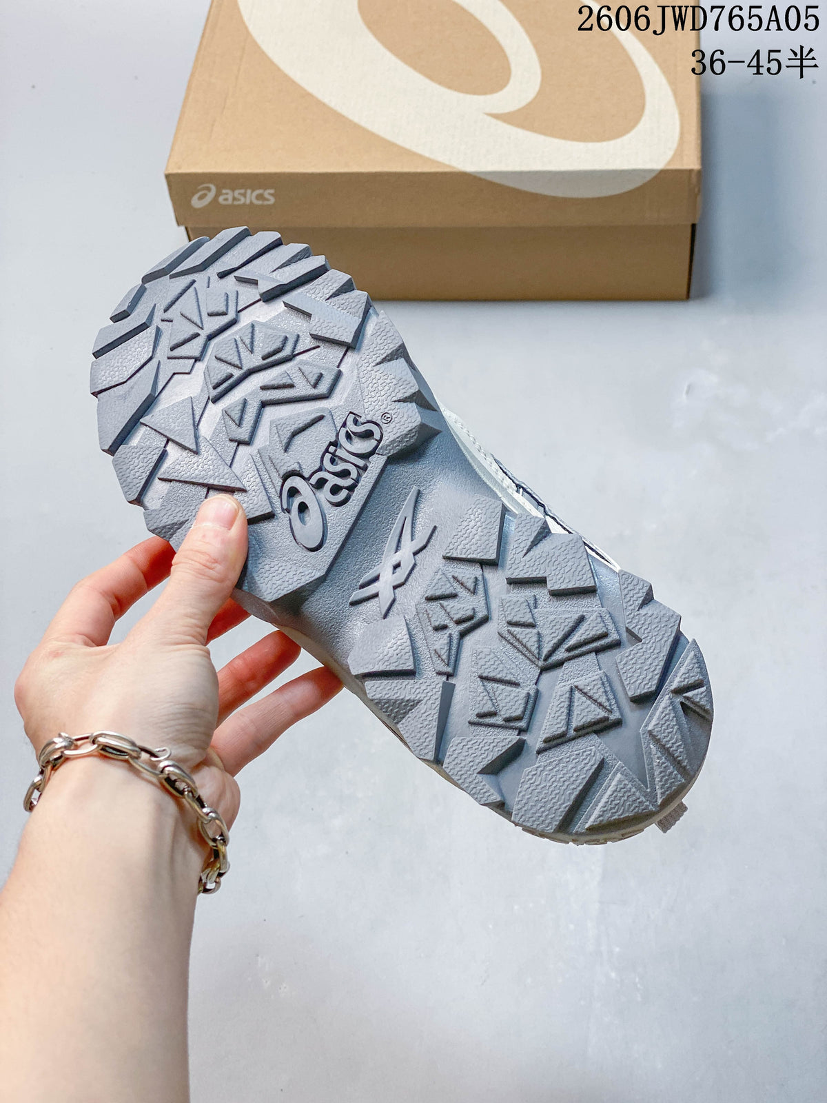 Close-up of the grey lugged outsole on an ASICS Gel-TRUCK sneaker