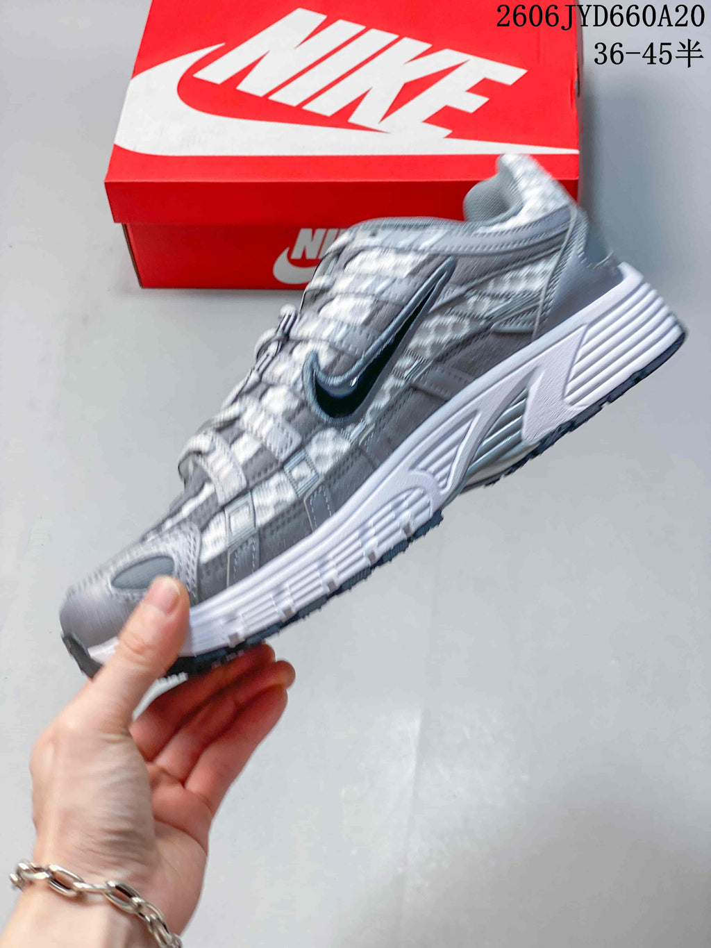 Side view showing the layered panels and dark Swoosh on a Nike P-6000 sneaker.