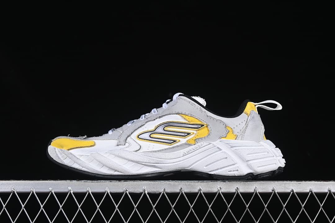Side view of grey, white and yellow Balenciaga Monday low-top sneakers
