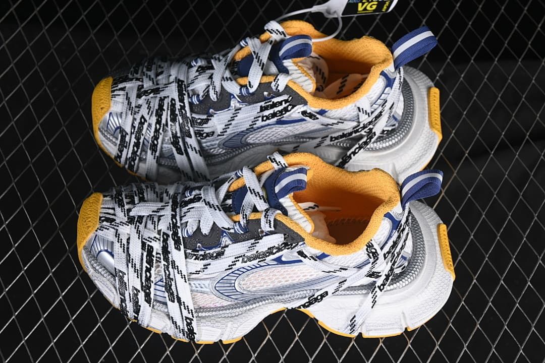Pair of white, navy, gray, and orange 3XL sneakers viewed from above