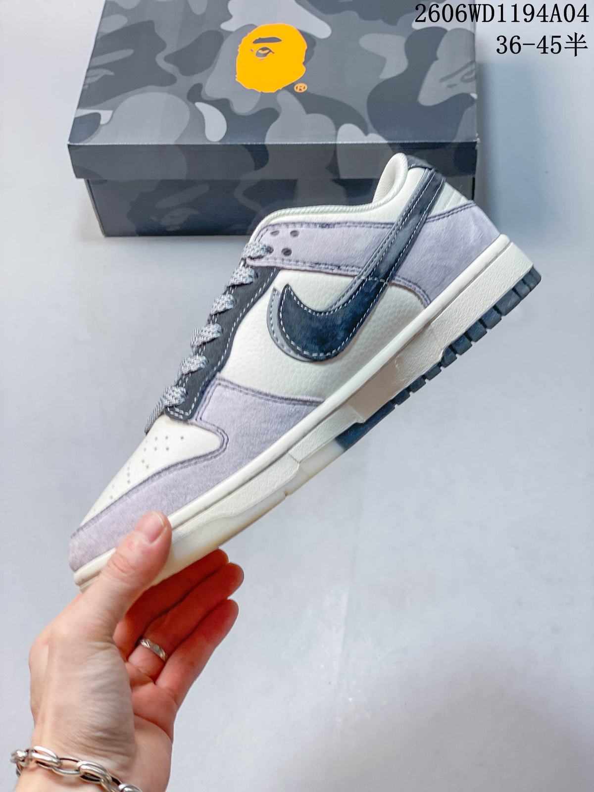 Side profile showing grey and off-white panels with a dark navy swoosh