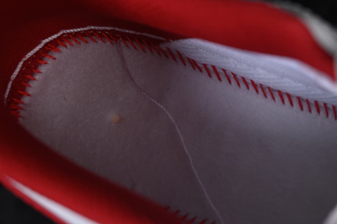 Close-up of the red-lined interior and stitched seam.
