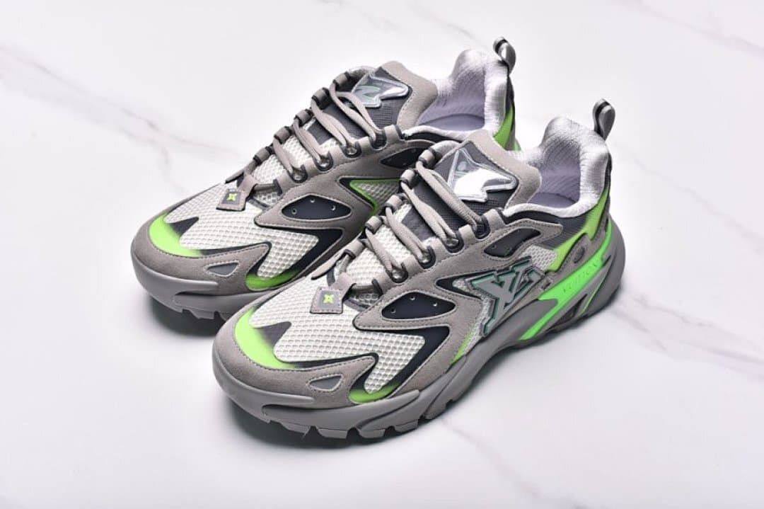 Angled overhead view of the pair of gray and green sneakers