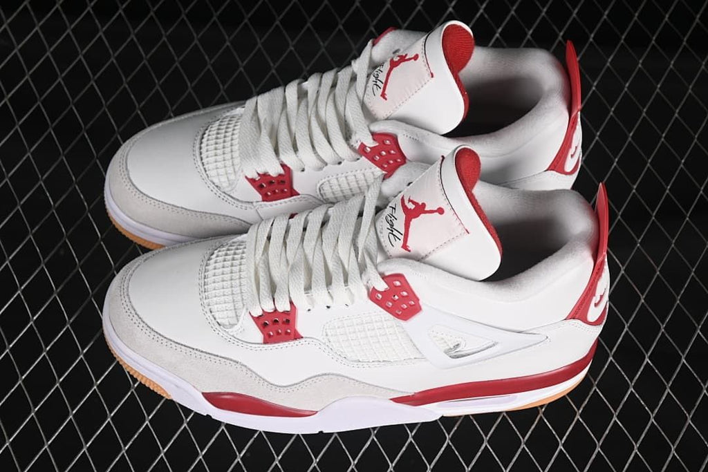 Pair of white and red sneakers shown from above