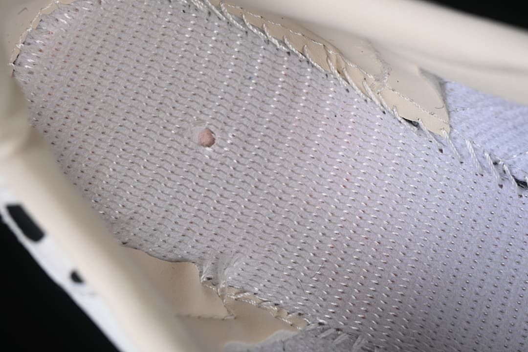 Close-up of the light-colored perforated shoe lining.