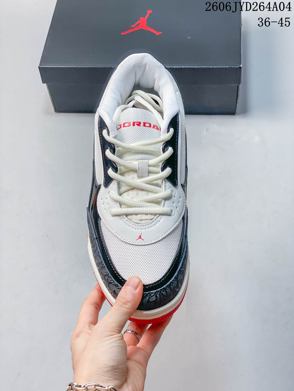 Front view of the sneaker showing white laces and contrasting overlays