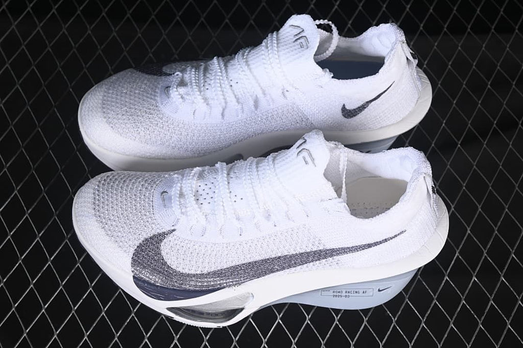Pair of white and grey Nike racing shoes shown from above and the side