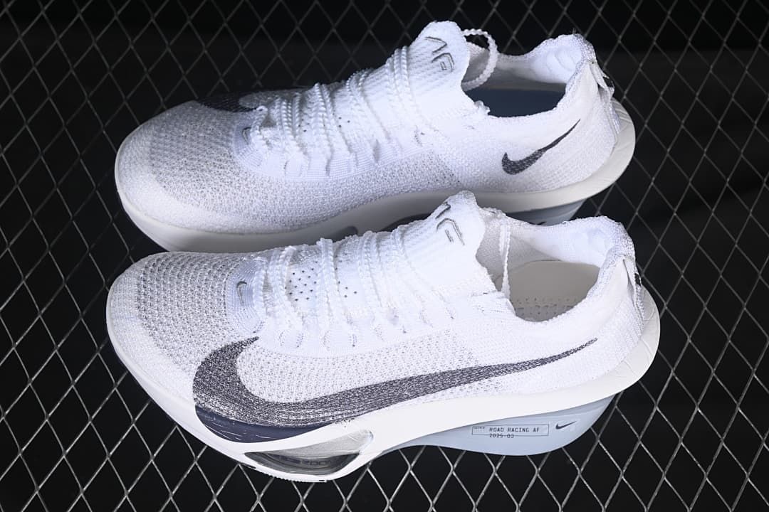 Pair of white and grey Nike racing shoes shown from above and the side