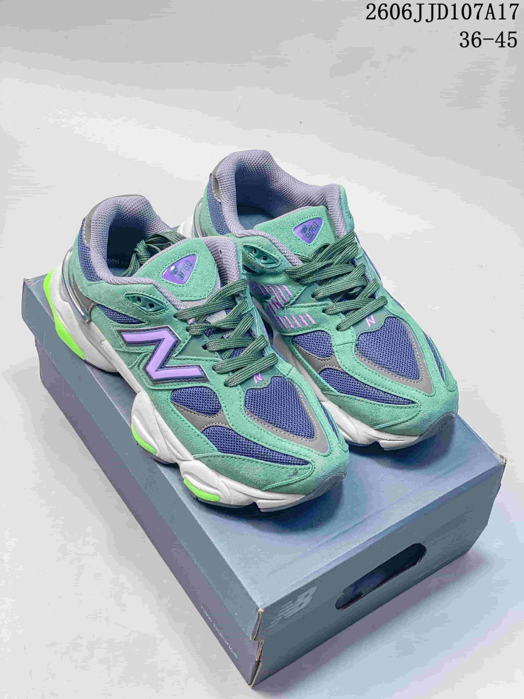 Pair of green New Balance U9060 sneakers with navy mesh, purple accents, and sculpted soles