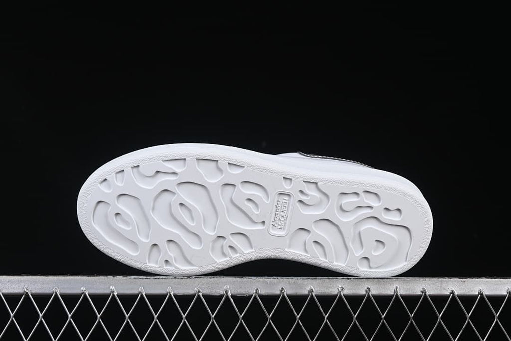 Underside view of the sneaker outsole with molded tread