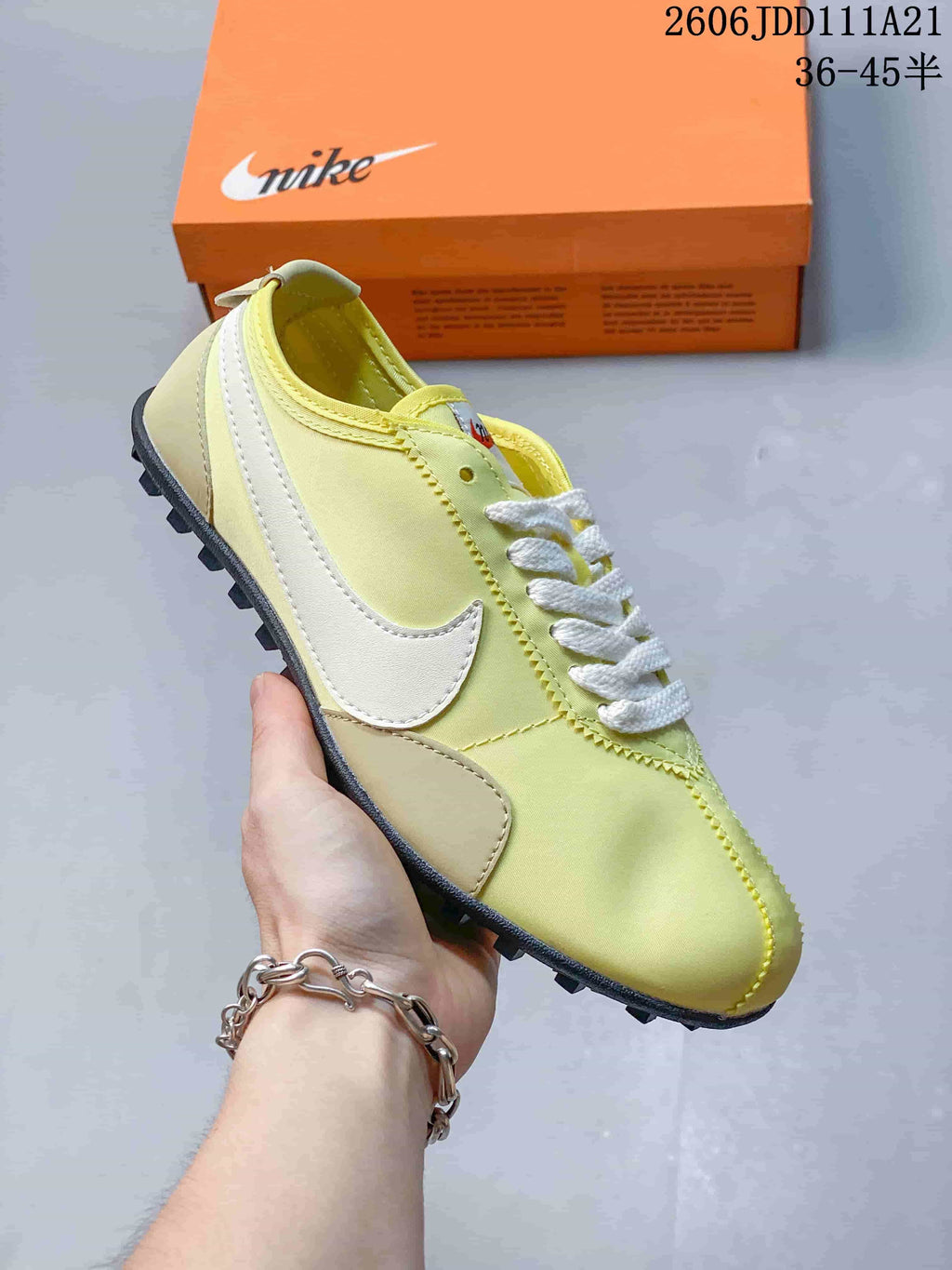 Pale yellow Nike Moon Shoe OG Summit low-top sneaker with a white Swoosh and dark outsole