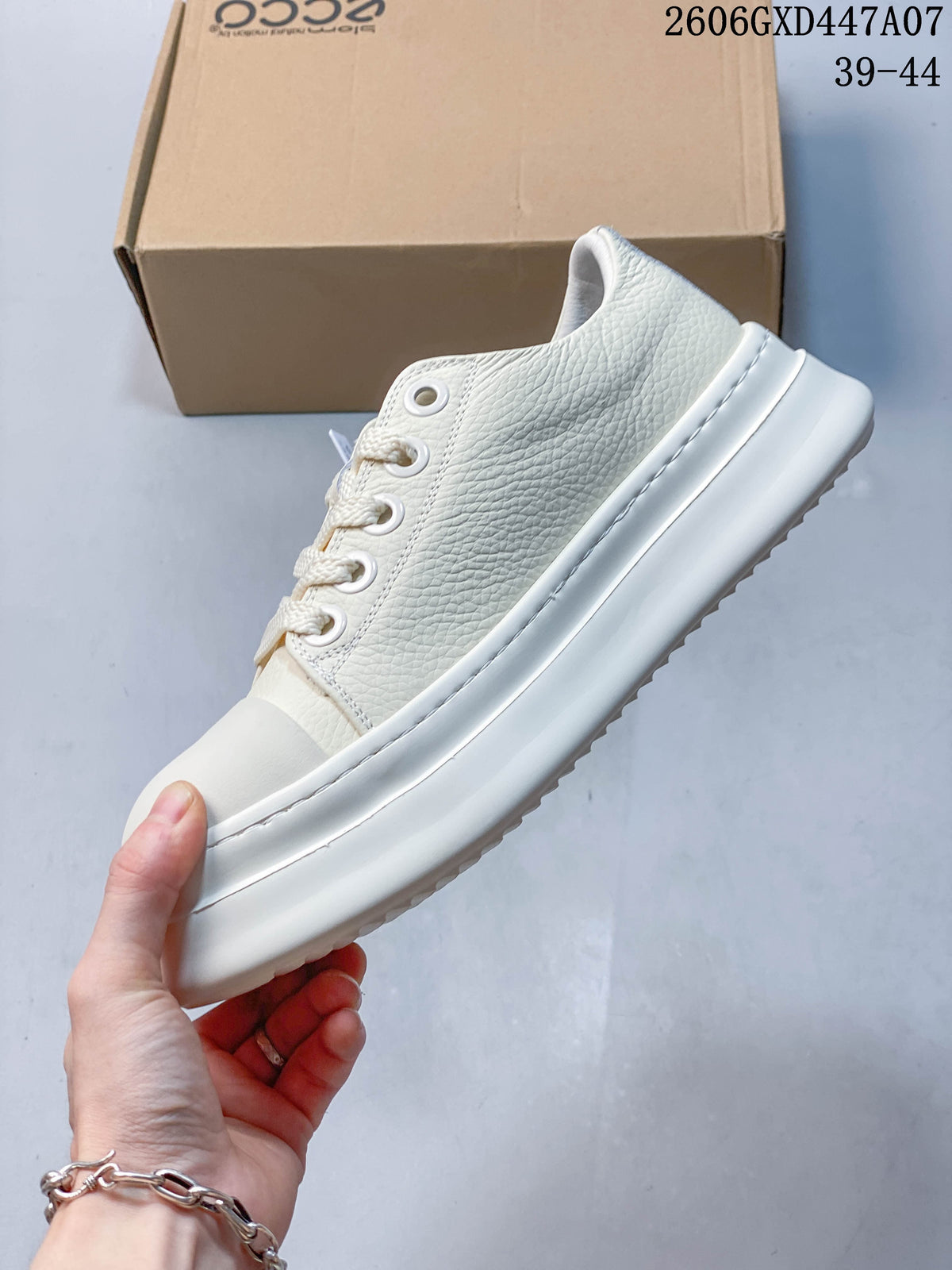 Side profile of the white textured sneaker with a thick platform-style sole