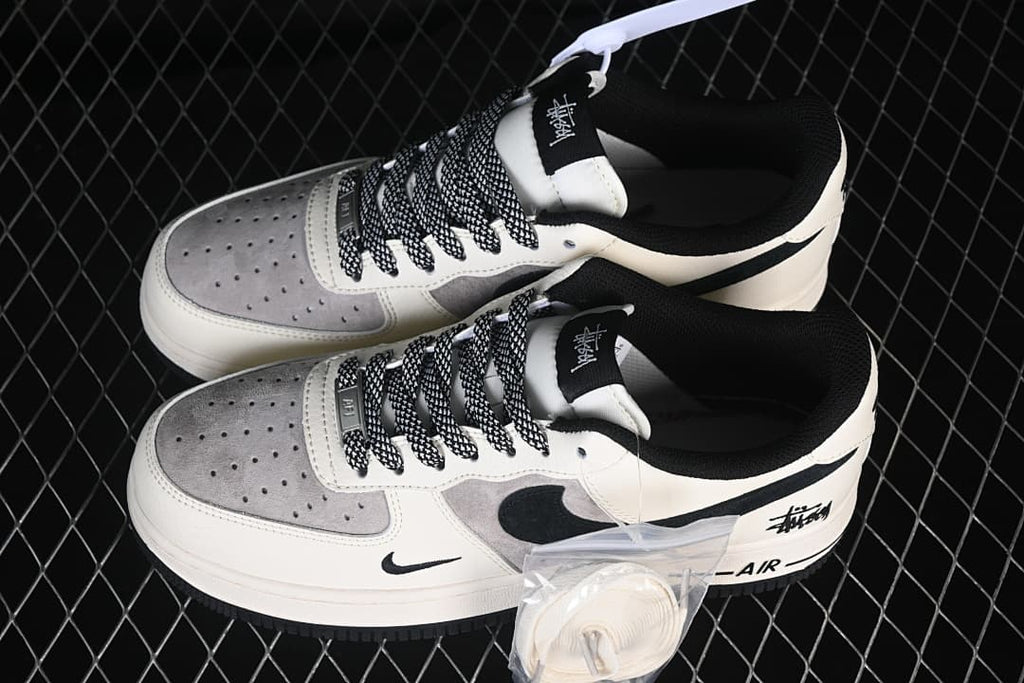 Pair of low-top sneakers shown from above with an extra set of white laces.