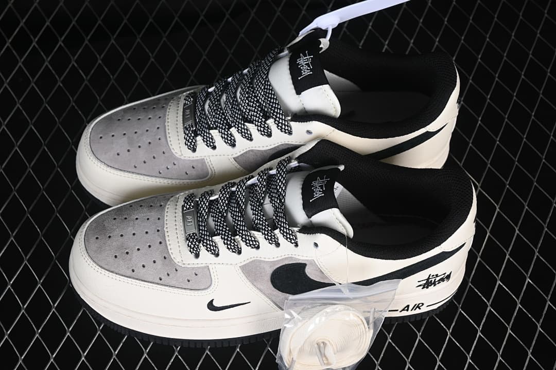 Pair of low-top sneakers shown from above with an extra set of white laces.