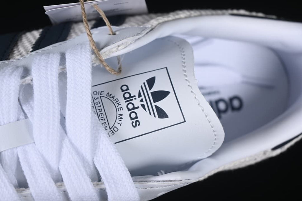 Close-up of the adidas tongue label and white laces