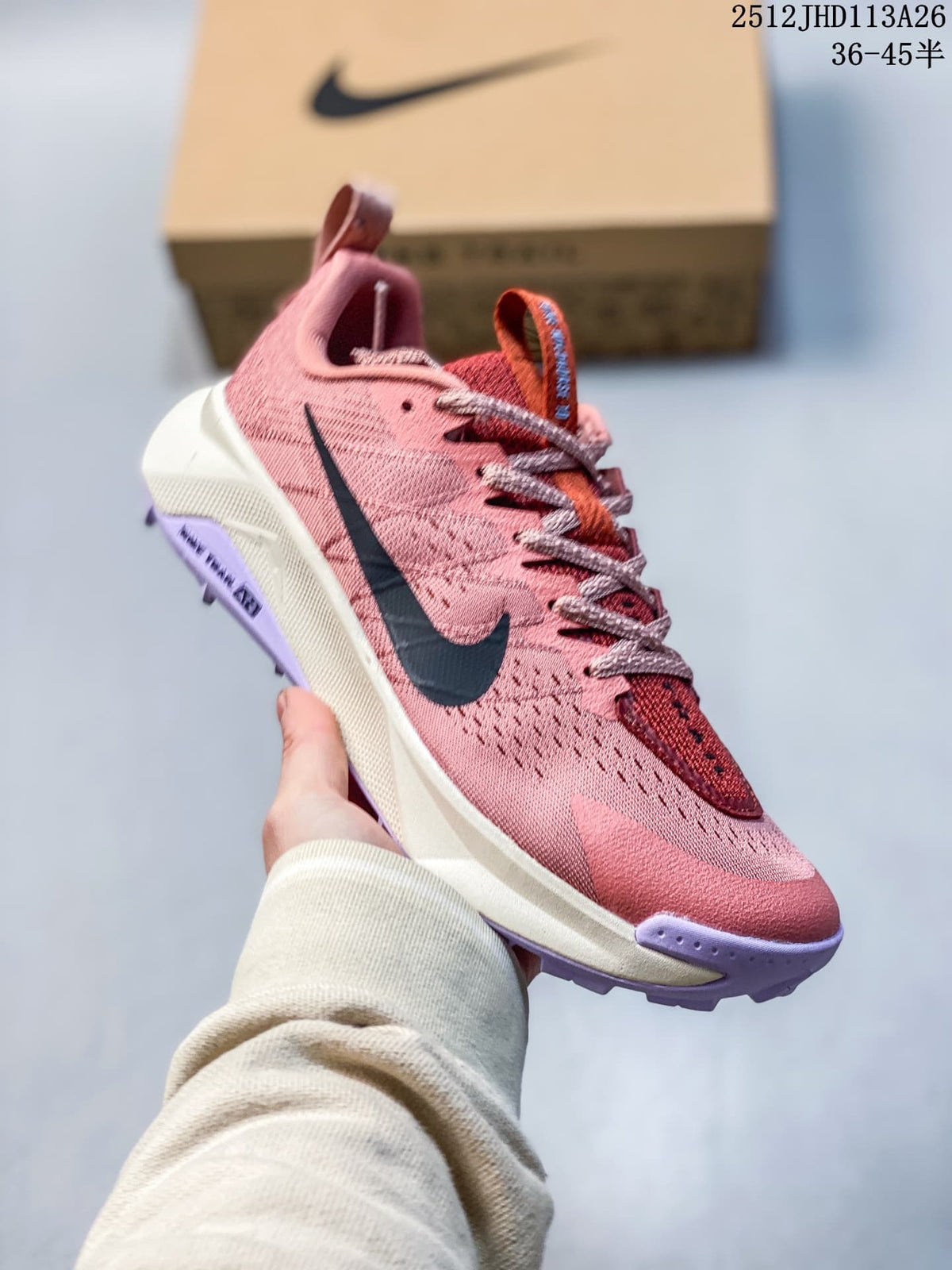Side view of the rose-pink Nike Wildhorse 10 trail running shoe.