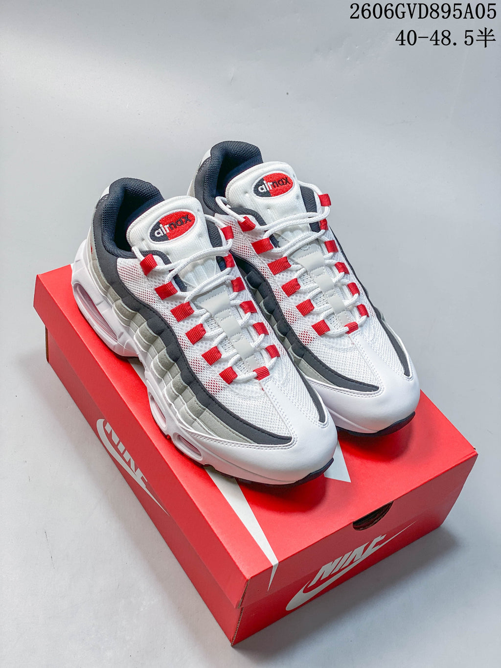 Nike Air Max 95 Big Bubble sneakers in white, grey, and red shown from above on a red shoe box.