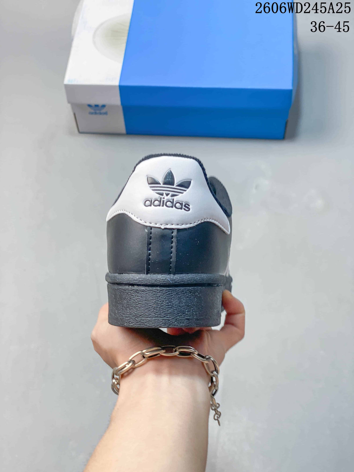 Rear view of the dark gray sneaker with a white heel tab