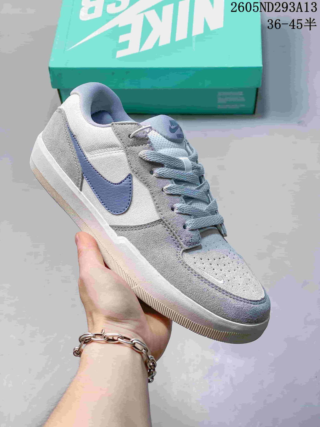 Pale grey Nike SB Force 58 sneaker with a blue-grey Swoosh